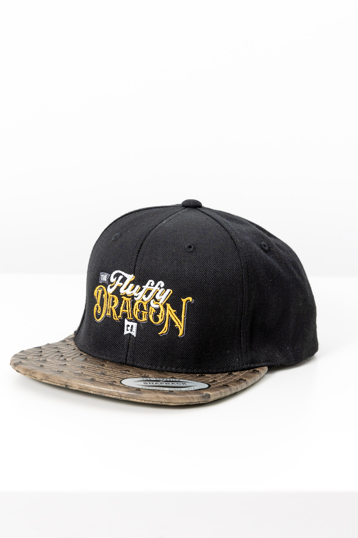 A black snapback hat with The Fluffy Dragon Co logo